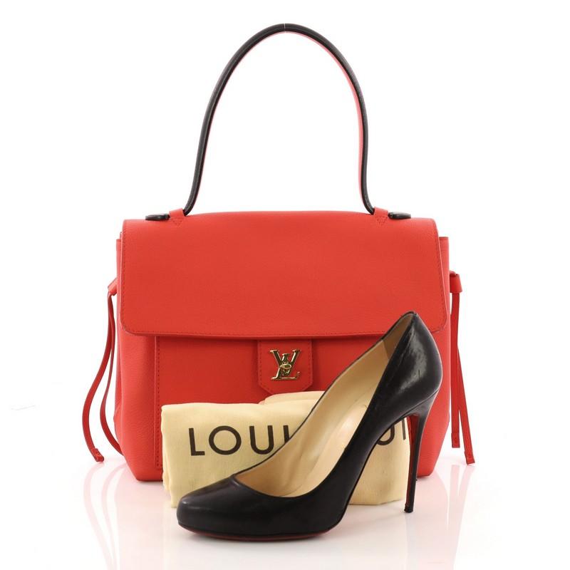 This authentic Louis Vuitton Lockme Handbag Leather PM is a must-have signature satchel made for the modern woman. Crafted in coral leather, this sophisticated yet feminine bag features a long leather top handle, side leather laces that cinch the