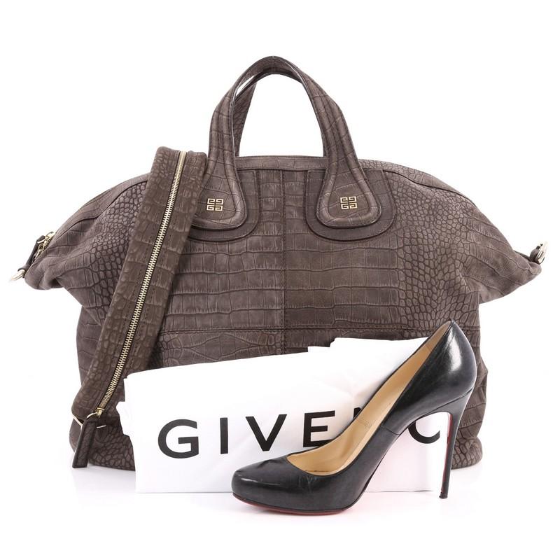 This authentic Givenchy Nightingale Satchel Crocodile Embossed Nubuck Large is a stylish and functional carry-all fit for all needs. Constructed in brown crocodile-embossed nubuck leather, this satchel is defined by its stitched quarters, Givenchy