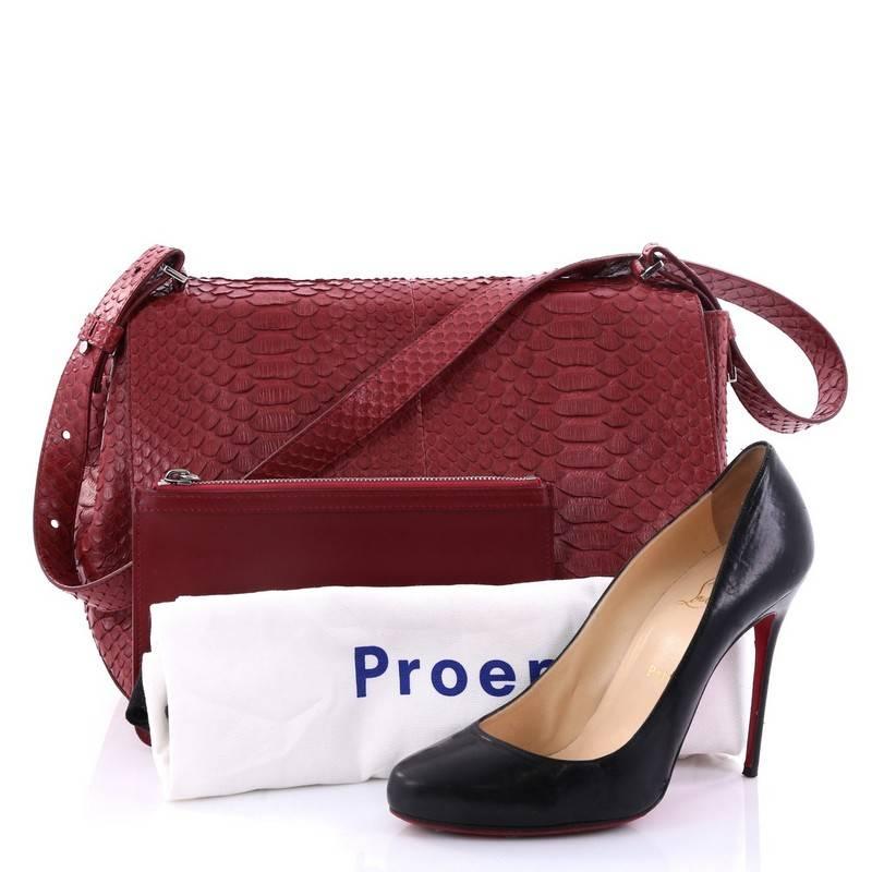 This authentic Proenza Schouler Courier Bag Python Large is a minimalist stylish bag loved by fashionistas. Crafted from genuine dark red python skin, this modern bag features adjustable snap-button shoulder strap, expandable snap sides, exterior