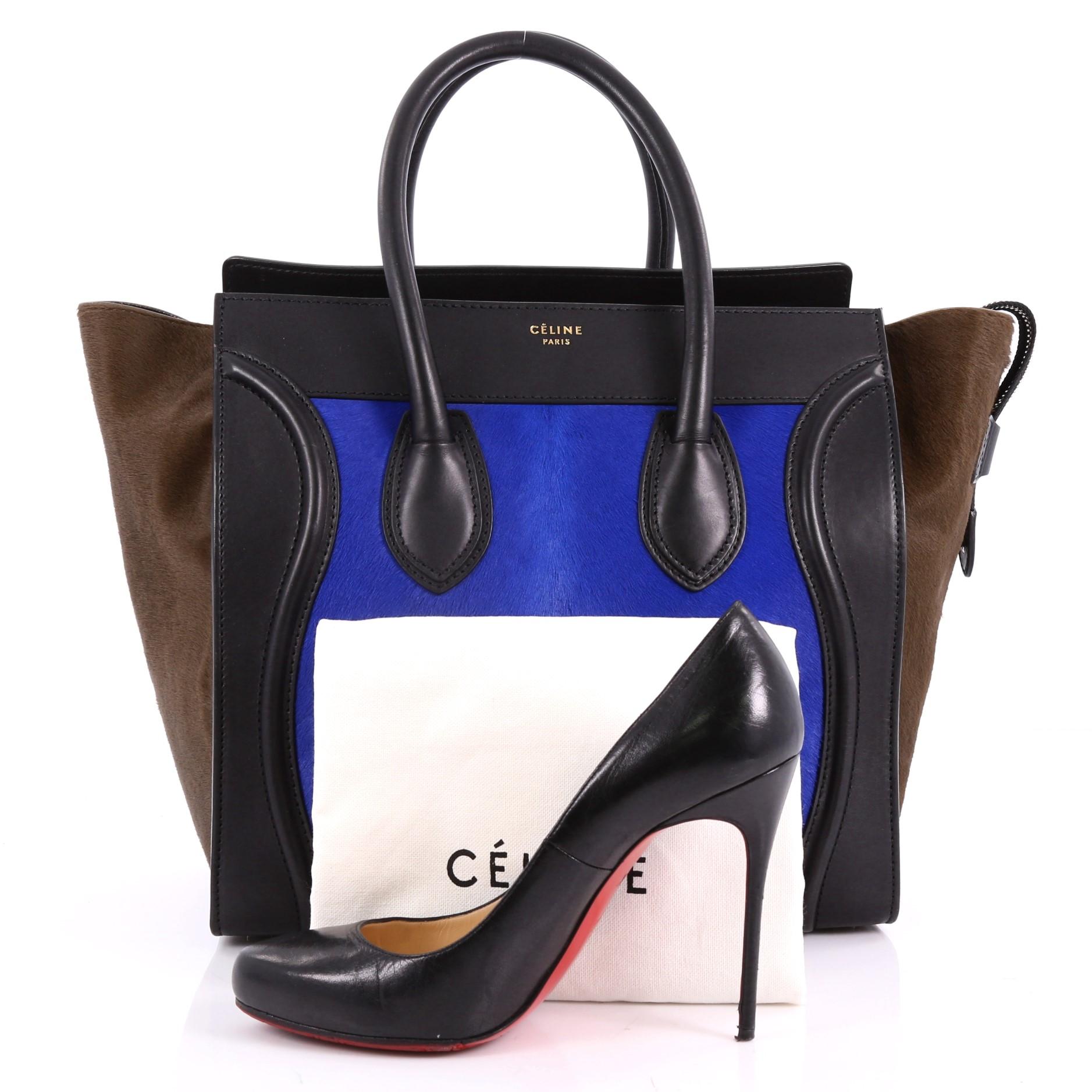 This authentic Celine Tricolor Luggage Handbag Pony Hair and Leather Mini is one of the most sought-after bags beloved by fashionistas. Crafted from genuine tricolor brown and blue pony hair with black leather, this minimalist tote features