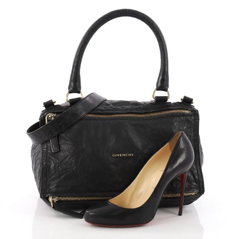 This authentic Givenchy Pandora Bag Distressed Leather Medium is the perfect companion for any on-the-go fashionista. Crafted from black distressed leather, this edgy and cult-favorite satchel features a pandora box-inspired silhouette, a singular