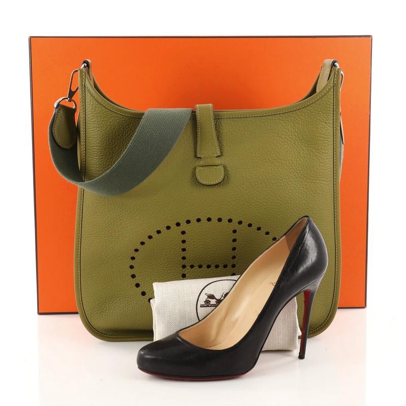 This authentic Hermes Evelyne Crossbody Gen II Clemence GM showcases a simple day-to-day style perfect for someone's first Hermes bag. Crafted from Vert Chartreuse clemence leather, this crossbody bag features a signature perforated H design at the