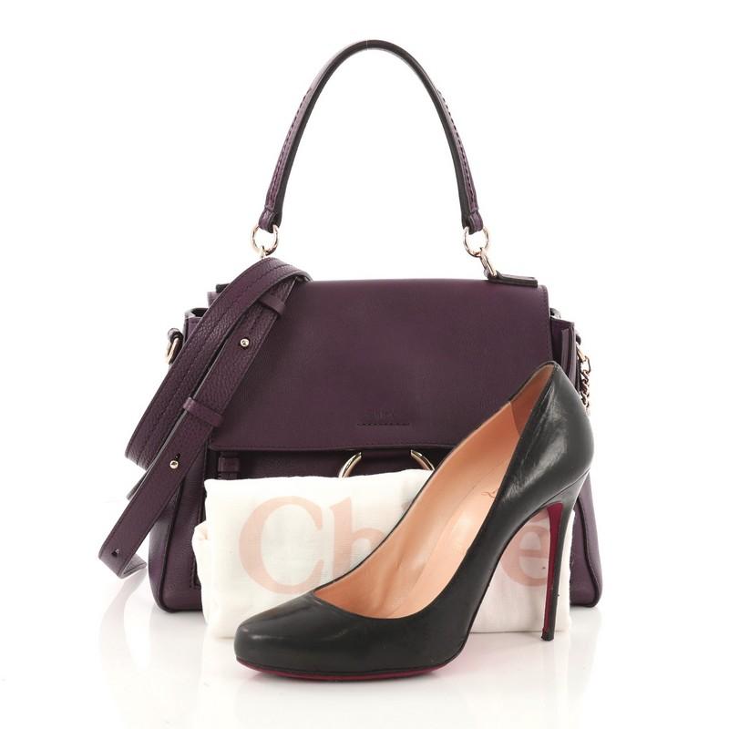 This authentic Chloe Faye Day Handbag Leather with Suede Small expresses casual elegance with a unique flair made for daily excursions. Crafted from purple leather, this chic bag features leather top handle, flap top with chain-clip and ring detail,