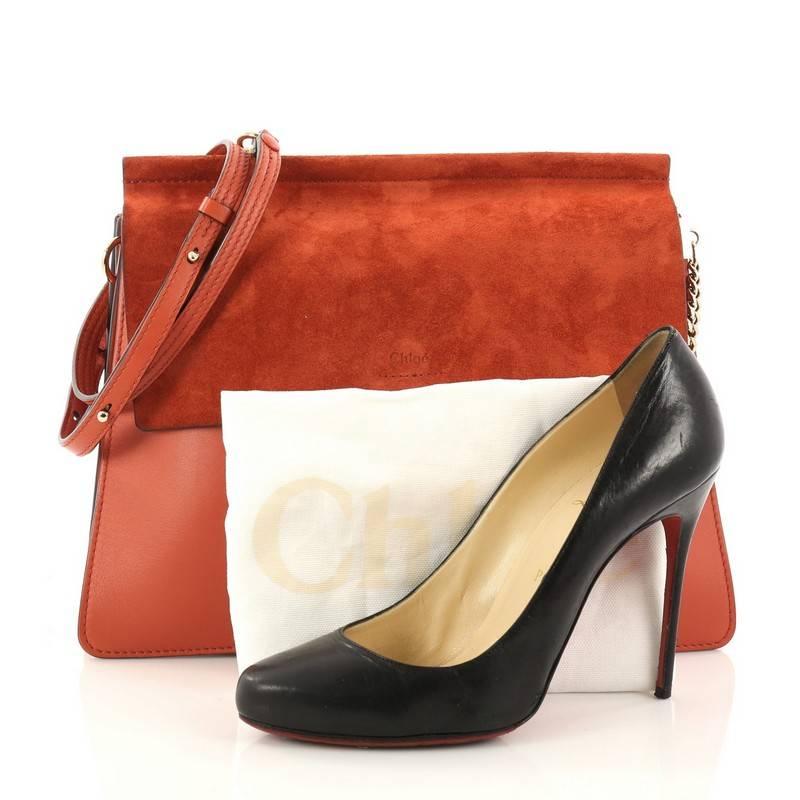 This authentic Chloe Faye Shoulder Bag Leather and Suede Medium personifies Chloe's unique luxe bohemian aesthetic with an ode to the 70's. Crafted in red leather and suede, this sleek bag features a ring with chain, gusseted sides, stamped logo at