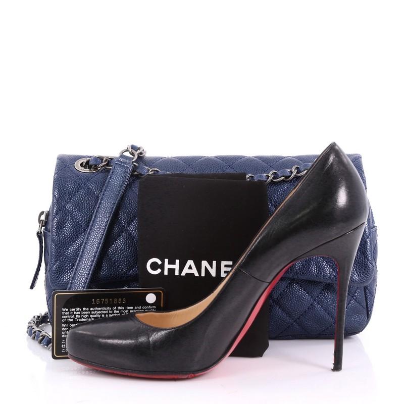 This authentic Chanel Easy Flap Bag Quilted Caviar Medium exudes a classic yet easy style made for the modern woman. Crafted from blue caviar leather with Chanel's signature diamond quilting design, this elegant flap features dual woven-in leather
