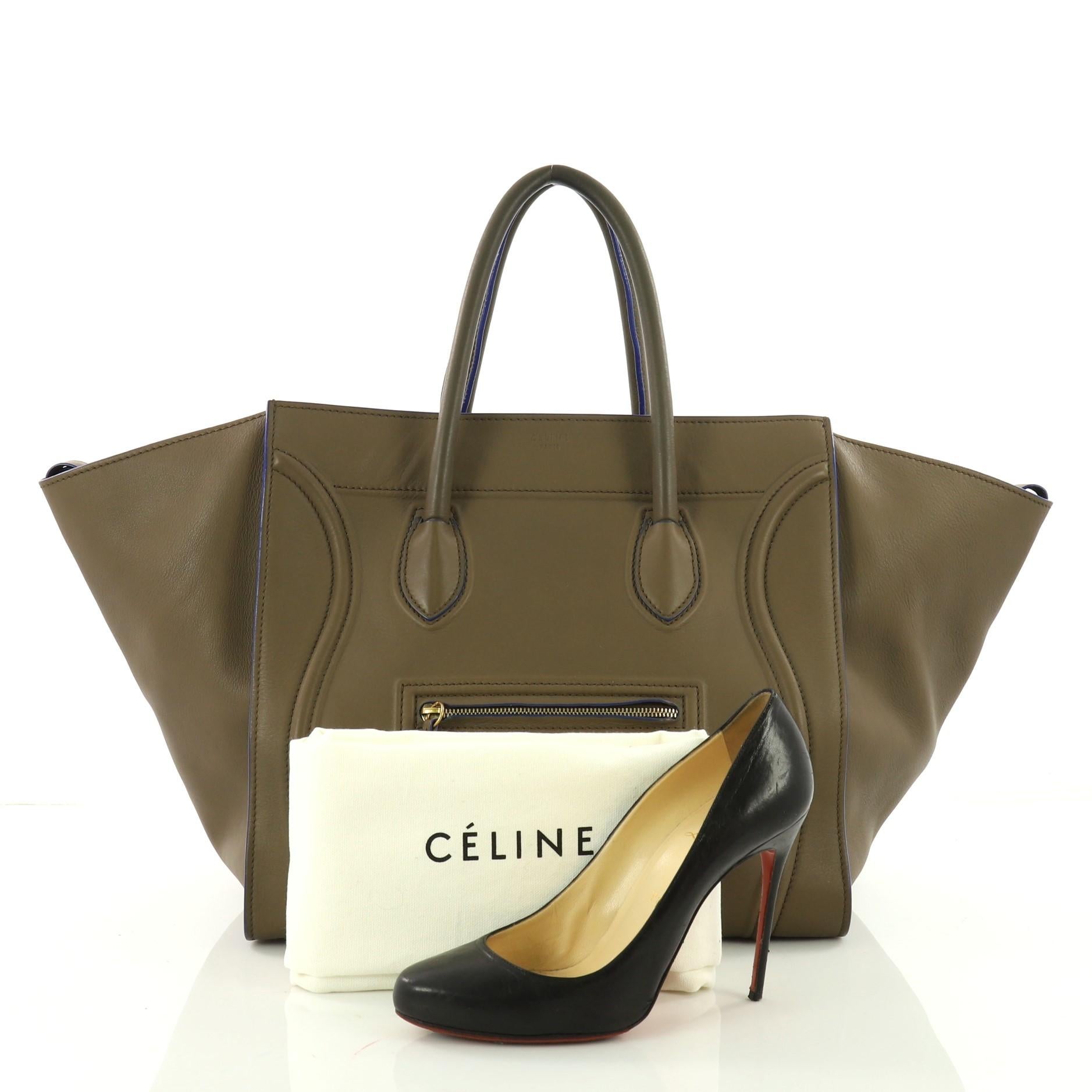 This authentic Celine Phantom Handbag Smooth Leather Large is one of the most sought-after bags beloved by fashionistas. Crafted from taupe smooth leather, this  tote features dual-rolled handles, an exterior front pocket, protective base studs,