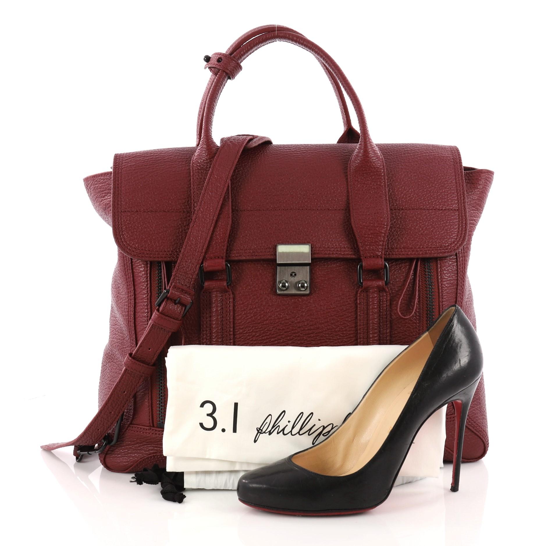 This authentic 3.1 Phillip Lim Pashli Satchel Leather Large is a practical bag with a stylish edge made for on-the-go moments. Crafted from maroon leather, this chic satchel features dual top handles, expandable zip sides, top flap push-lock closure