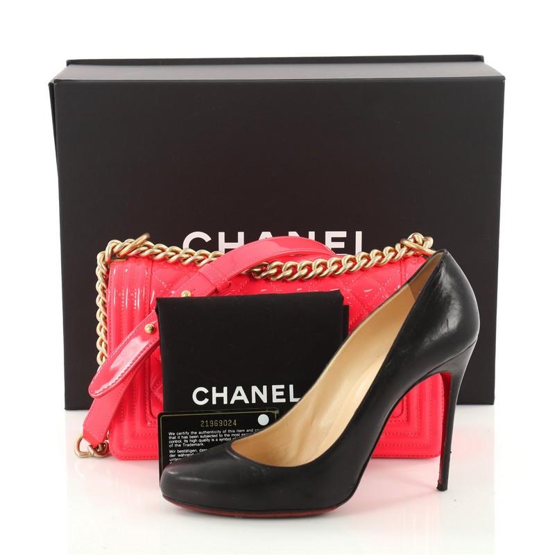 This authentic Chanel Boy Flap Bag Quilted Patent Old Medium is every woman’s dream. Crafted in neon pink quilted patent leather, this popular bag features gold chain link straps with leather pad, iconic CC logo boy push-lock and gold-tone hardware