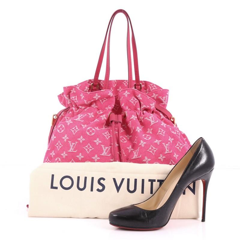 This authentic Louis Vuitton Noefull Handbag Denim MM combines the Noe and Neverfull style, making this chic and fresh bag a necessity for Louis Vuitton lovers. Crafted in pink monogram denim with pink leather trims, this bag features dual slim