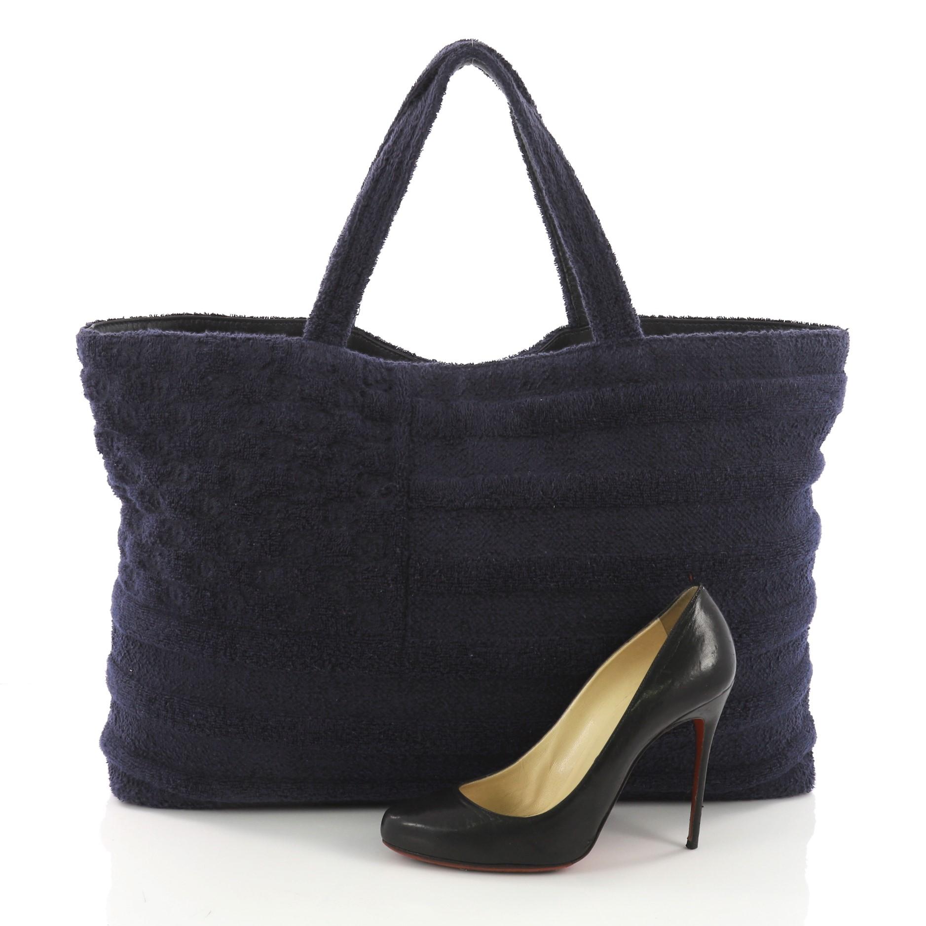 This Chanel Flag Beach Tote Terry Cloth Large, crafted in navy blue terry cloth, features dual top handles, and gunmetal-tone hardware. It opens to a maroon terry cloth interior with side zip and slip pockets. **Note: Shoe photographed is used as a