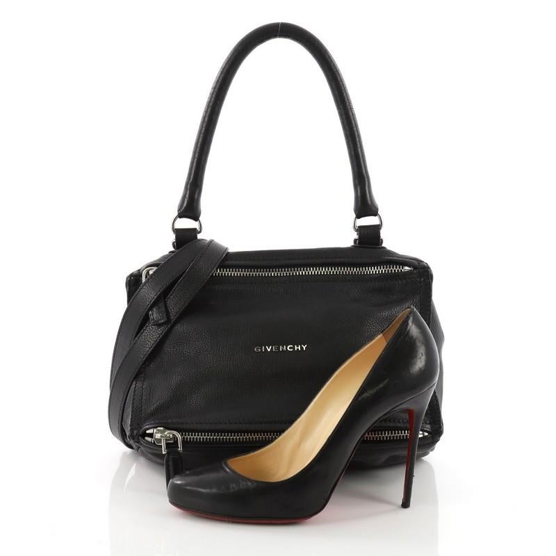 This Givenchy Pandora Bag Leather Small, crafted from black leather, features a singular top handle, Givenchy logo at the center, and silver-tone hardware. Its two-way zip fastenings open to a black fabric interior with side zip and slip pockets.