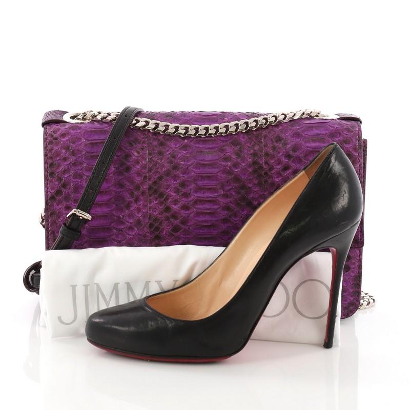 This Jimmy Choo Rebel Soft Chain Crossbody Bag Python Small, crafted in genuine purple python skin, features chain-link shoulder strap, leather strap, and silver-tone hardware. Its flip-lock closure opens to a taupe suede interior divided into two