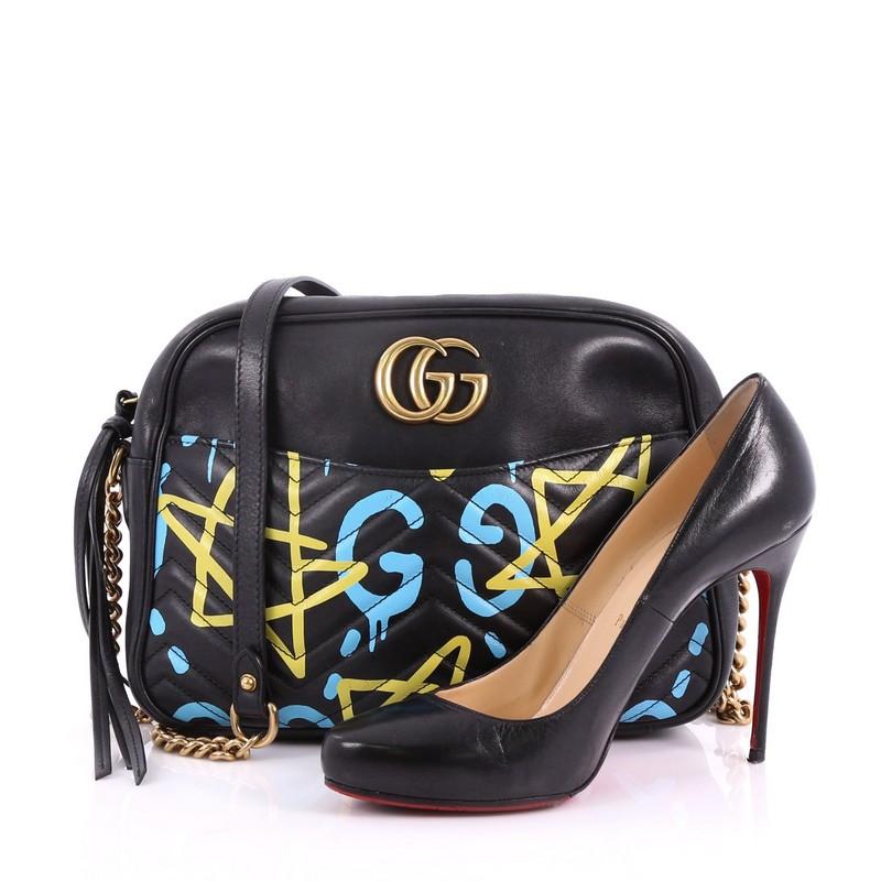 This Gucci GG Marmont Shoulder Bag GucciGhost Matelasse Leather Medium, crafted from black, yellow and blue GucciGhost print matelasse quilted leather, features chain-link shoulder strap, double G logo and gold-tone hardware. Its zip closure opens