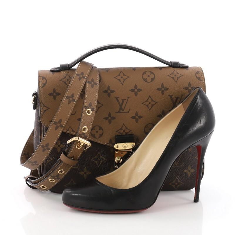 This Louis Vuitton Pochette Metis Reverse Monogram Canvas, crafted from brown reverse monogram coated canvas, features a top leather handle, exterior back zip pocket, and gold-tone hardware. Its s-lock closure opens to a black microfiber interior