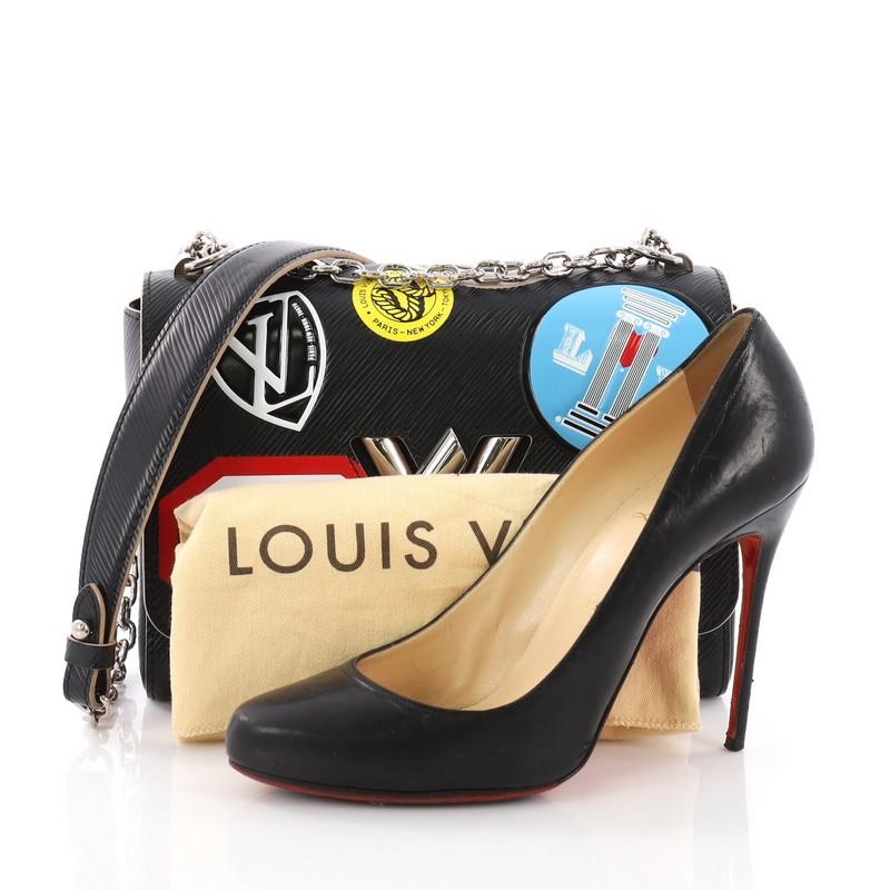 This Louis Vuitton Twist Handbag Limited Edition World Tour Epi Leather MM, crafted in black epi leather, features long silver chain straps with leather pad, world tour stickers, and silver-tone hardware. Its twist-lock closure opens to a black