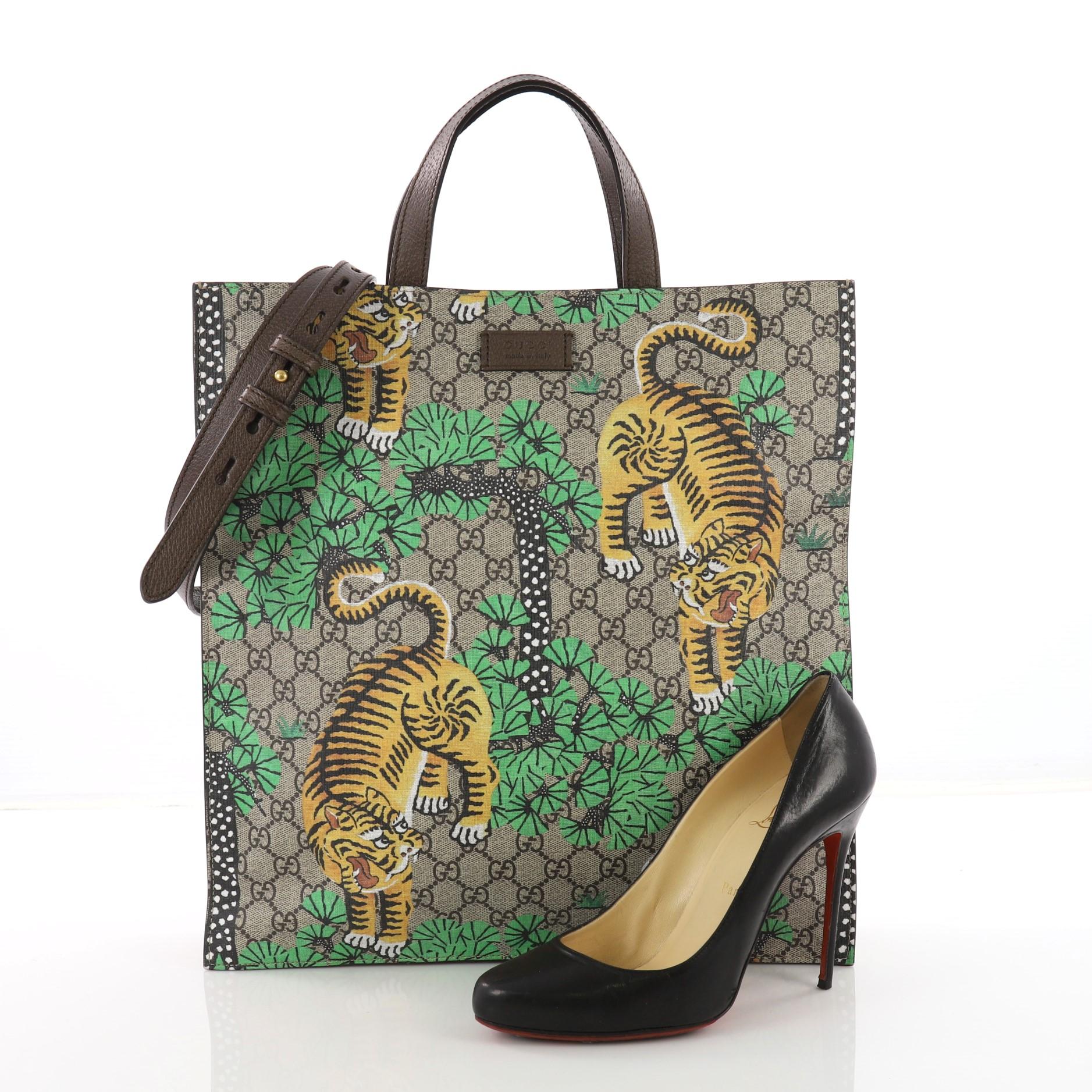 This Gucci Convertible Soft Open Tote Bengal Print GG Coated Canvas Tall, crafted in taupe Bengal printed GG coated canvas, features dual flat handles, adjustable shoulder strap, and aged bronze-tone hardware accents. Its magnetic closure opens to a