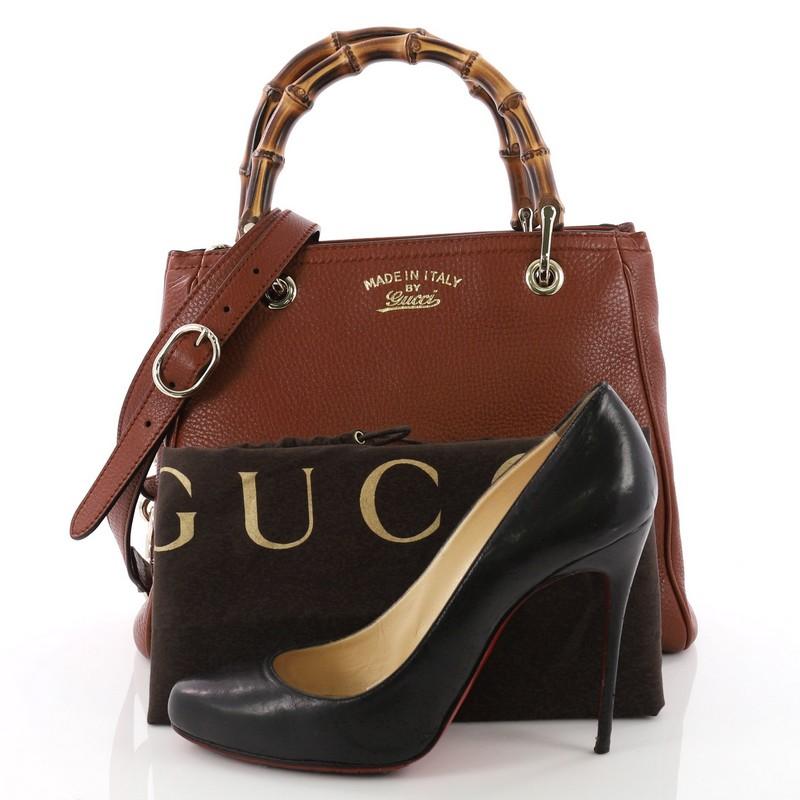 This authentic Gucci Bamboo Shopper Tote Leather Small is a classic must-have. Crafted in brown leather, this simple yet stylish tote features Gucci's signature sturdy bamboo handles, protective base studs, stamped logo at the front and bamboo and