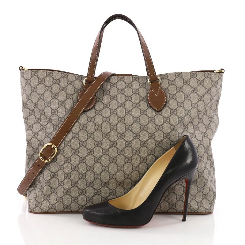 This Gucci Convertible Soft Tote GG Coated Canvas Small, crafted from brown GG supreme coated canvas, features dual rolled handles and gold-tone hardware. Its magnetic snap closure opens to a beige microfiber interior with side zip and slip pockets.