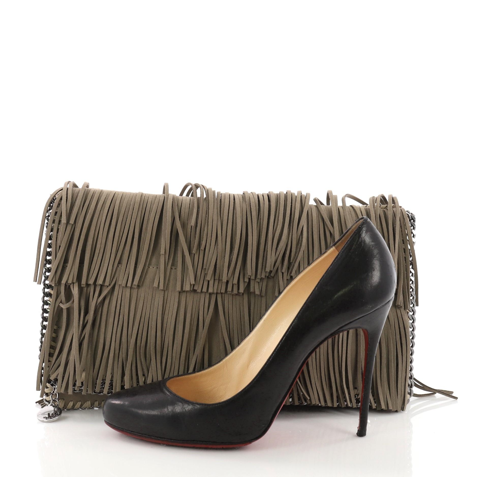 This Stella McCartney Falabella Fringe Flap Clutch Faux Suede, crafted from taupe faux suede, features silver trims and whipstitched edges, fringe detailing and silver-tone hardware. Its magnetic snap closure opens to a black fabric interior.