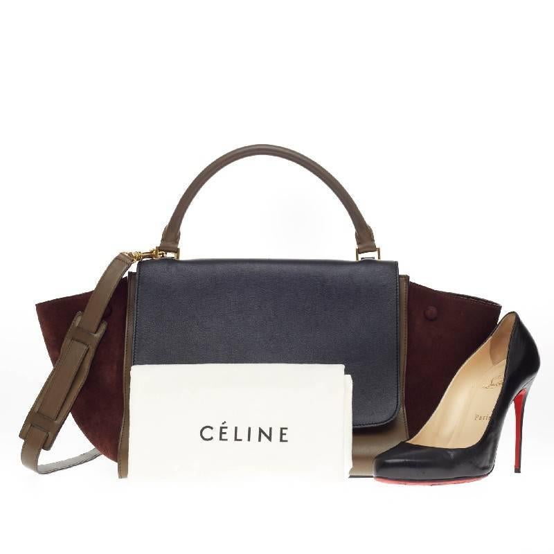 This authentic Celine Trapeze Tricolor Leather and Suede Medium is a modern classic, featuring a fall-ready palette of khaki and dark gray leather body with burgundy suede wings. With its subdued color palette, gold hardware and minimalist design,