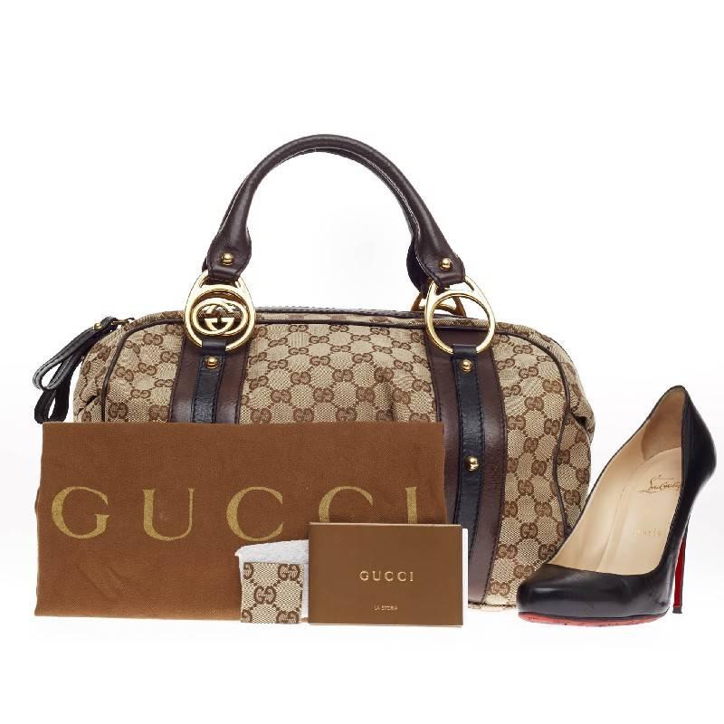 This authentic Gucci Interlocking Boston GG Canvas Medium is a recognizable classic. Crafted in GG brown monogram canvas, this easy-to-carry bag features dual-rolled handles, signature brown and black leather trims, protective base studs and