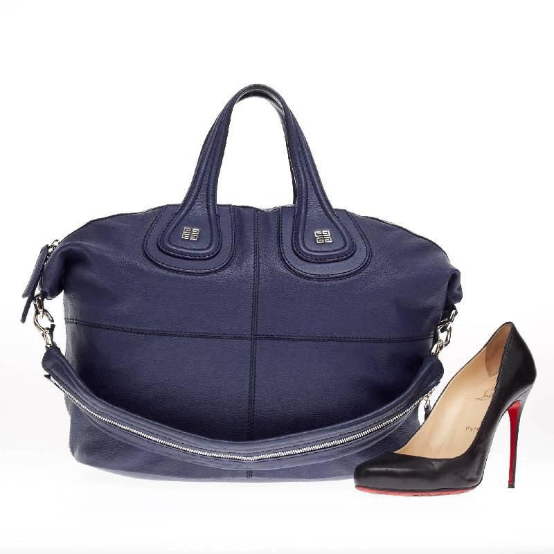 This authentic Givenchy Nightingale Satchel Leather Medium is a stylish and functional carry-all fit for all needs. Constructed in rich navy blue leather, this satchel is defined by its stitched quarters, embossed Givenchy logo emblem at its