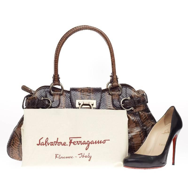 This authentic Salvatore Ferragamo Marisa Satchel Python is beautifully crafted in brown genuine glazed python skin perfect for day to night. This exotic yet feminine bag showcases dual rolled handles, buckle details and matte gold-tone hardware