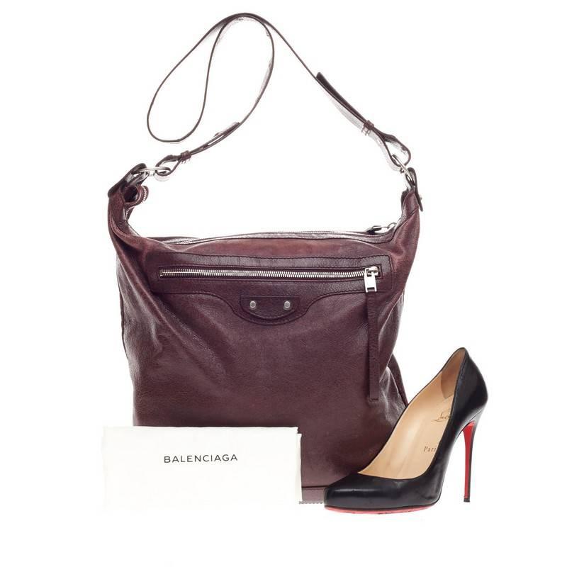This authentic Balenciaga Day Messenger Classic Studs Leather is a versatile staple piece for any day. Crafted in wine burgundy distressed leather, this messenger bag features a  front zip pocket, iconic Balenciaga classic stud details, adjustable