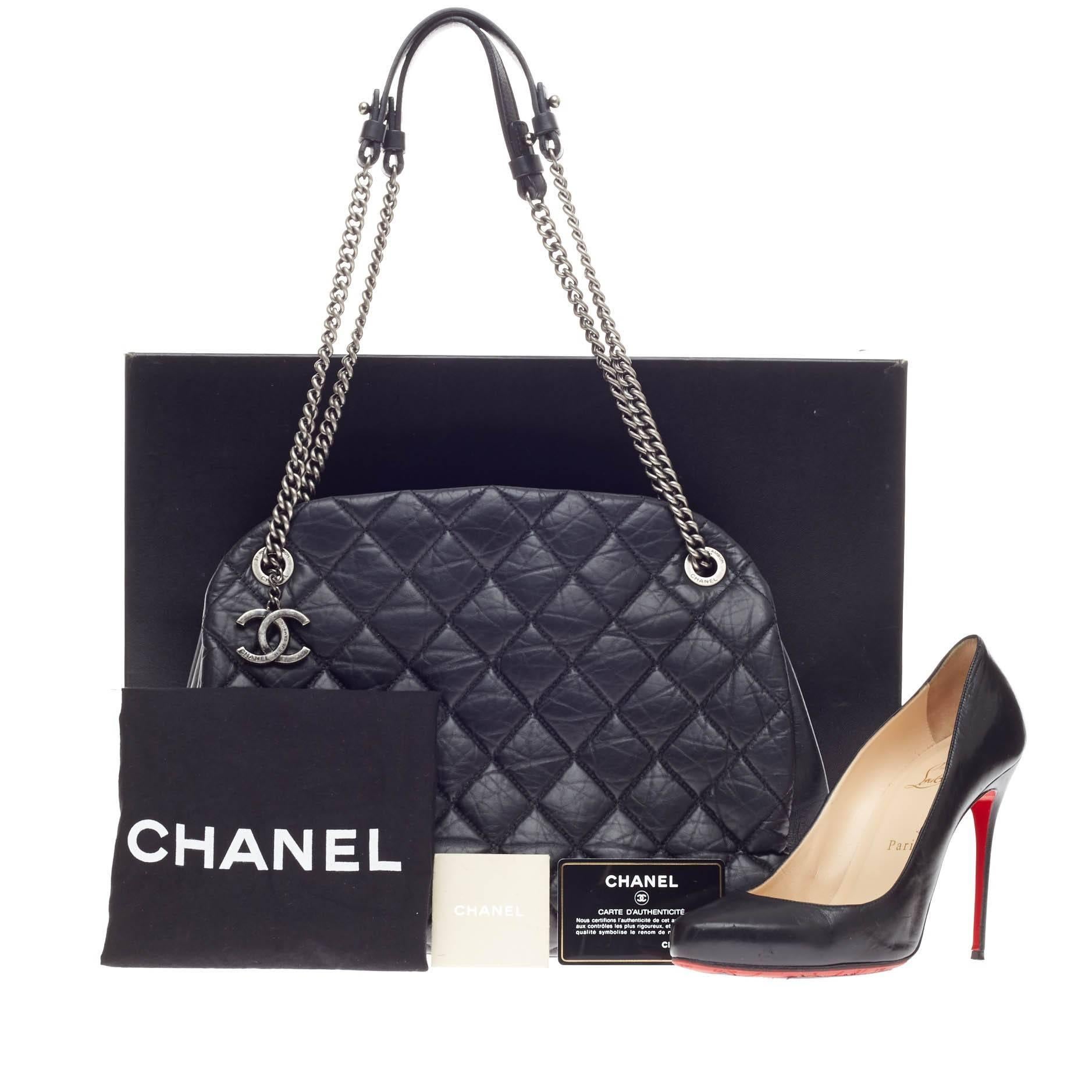 This authentic Chanel Stitched Mademoiselle Bowling Bag Aged Calfskin Large is a classic design with an edgy flair. Crafted in black diamond quilted distressed calfskin leather, this bowling bag features ruthenium chain strap with pads, protective