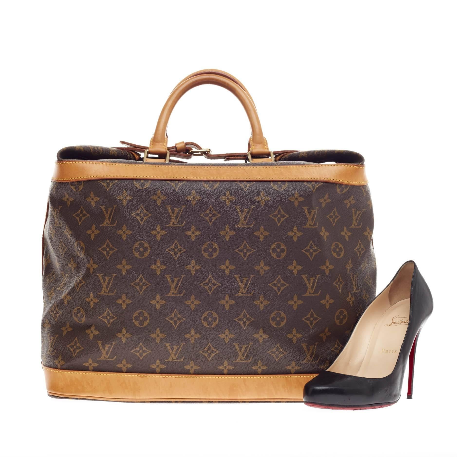 This authentic Louis Vuitton Cruiser Monogram Canvas 40 showcases the brand's timeless and luxurious style and functionality. Crafted in Louis Vuitton's iconic monogram canvas print, this chic travel box luggage features dual-rolled handles, cowhide