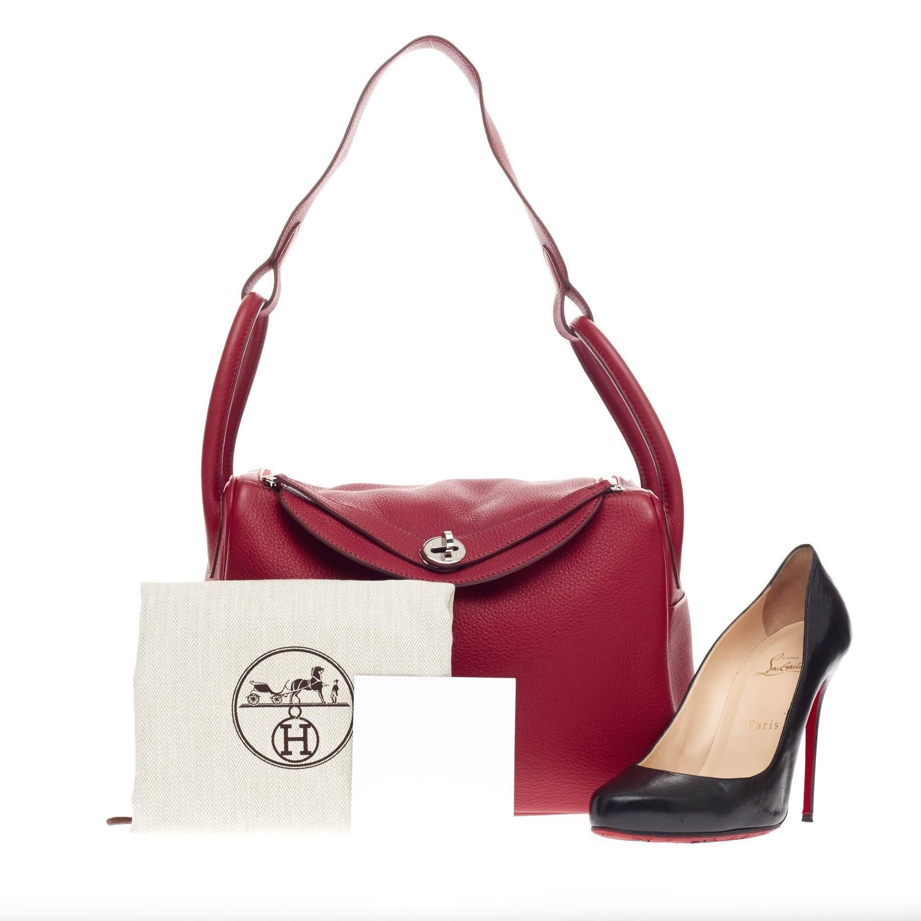 This authentic Hermes Lindy Clemence 30 in beautiful Rouge Garance clemence leather is the perfect understated accessory for the modern woman. Accented in polished palladium hardware,  this no-fuss shoulder bag features dual rolled handles, two