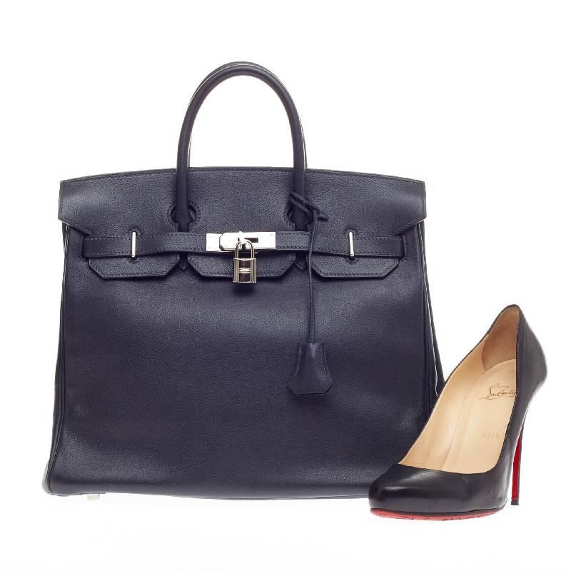This authentic Hermes Birkin HAC Indigo Evergrain with Palladium Hardware 32 exudes traditional Hermes luxury. Crafted in indigo evergrain leather, this unique birkin HAC modeled after regular Birkins, stands at taller proportions with slightly