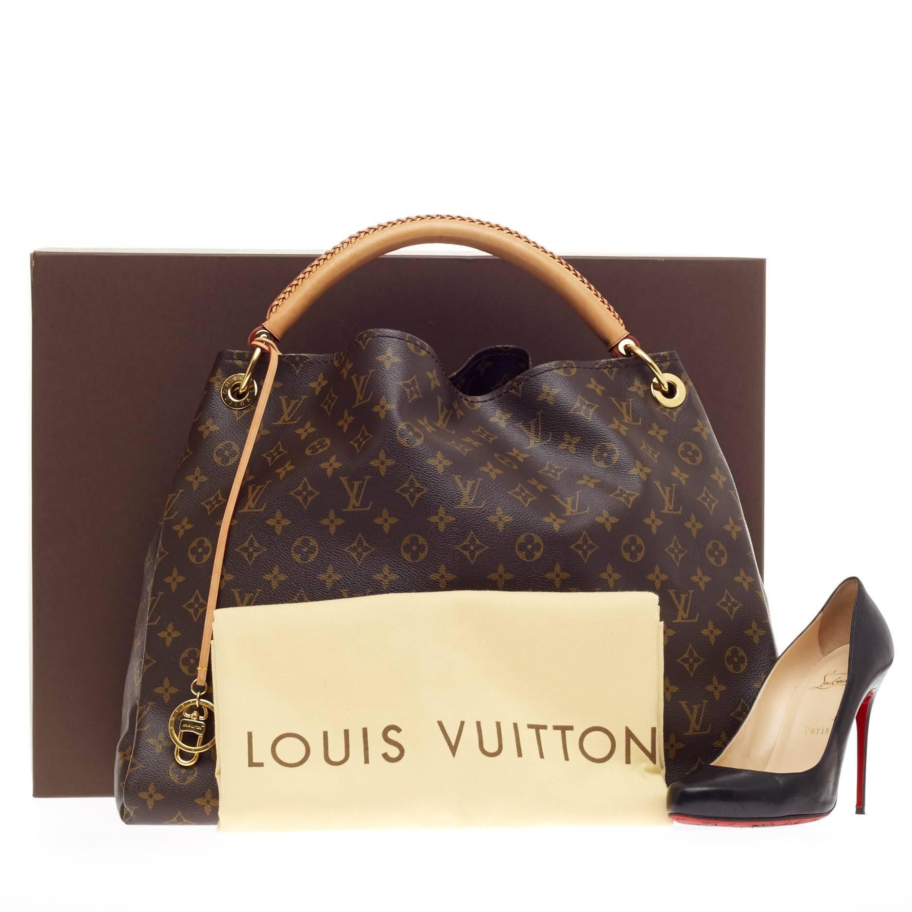 This authentic Louis Vuitton Artsy Monogram Canvas GM is an elegant and iconic bag that adds a stylish flair to any outfit. Crafted from Louis Vuitton's iconic monogram canvas and featuring a single looped hand-crafted leather handle, this roomy