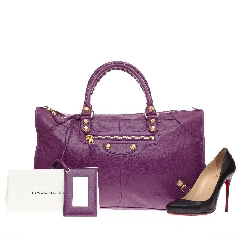 This authentic Balenciaga Work Giant Studs Leather is true to the brand's easy, luxe aesthetic. Crafted in beautiful distressed ultraviolet leather, this tote features Balenciaga's signature giant gold studs, a front zip pocket, braided