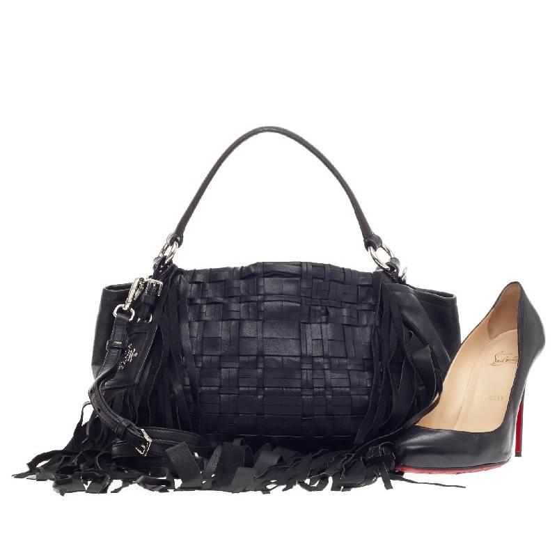This authentic Prada Convertible Fringe Shoulder Bag Woven Nappa Leather balances a traditional boho design with a chic and sleek twist perfect for modern fashionistas. Crafted in nero black woven nappa leather, this stylish tote features cascading