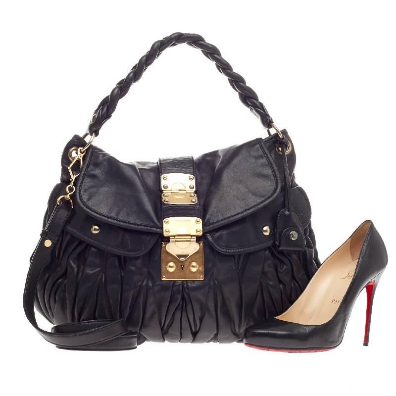 This authentic Miu Miu Coffer Hobo Matelasse Leather is crafted in a feminine ruched design that is unique to the brand. Designed in fine lambskin black leather, this beautiful bag features classic gold-tone hardware, a black fabric interior with a
