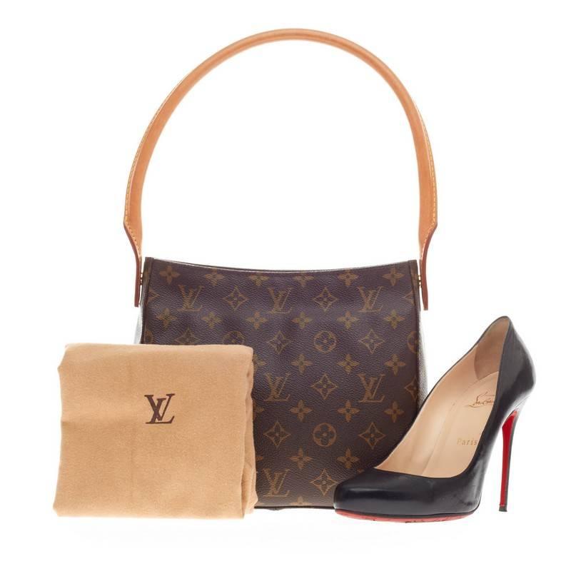 This authentic Louis Vuitton Looping Monogram Canvas MM is sturdy in its size and showcases the brand's monogram canvas print. The standard of the Looping collection, this bag features an arched natural vachetta leather handle giving the bag