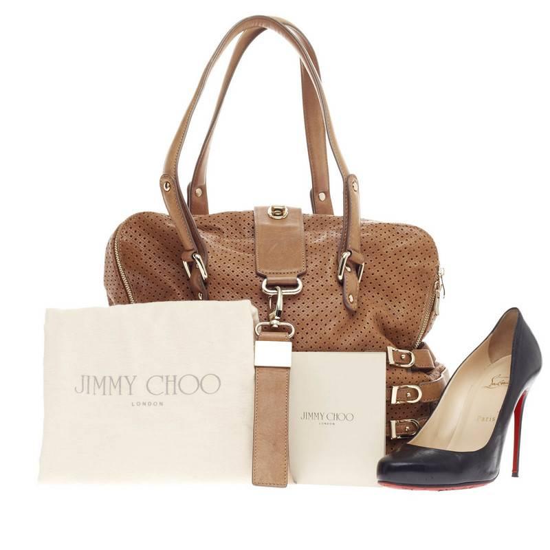 This authentic Jimmy Choo Blythe Tote Perforated Leather Large released in 2010 is sporty yet chic in design. Crafted in sandy brown perforated leather, this tote features tall dual-flat handles, side belt and buckle strap details laced through