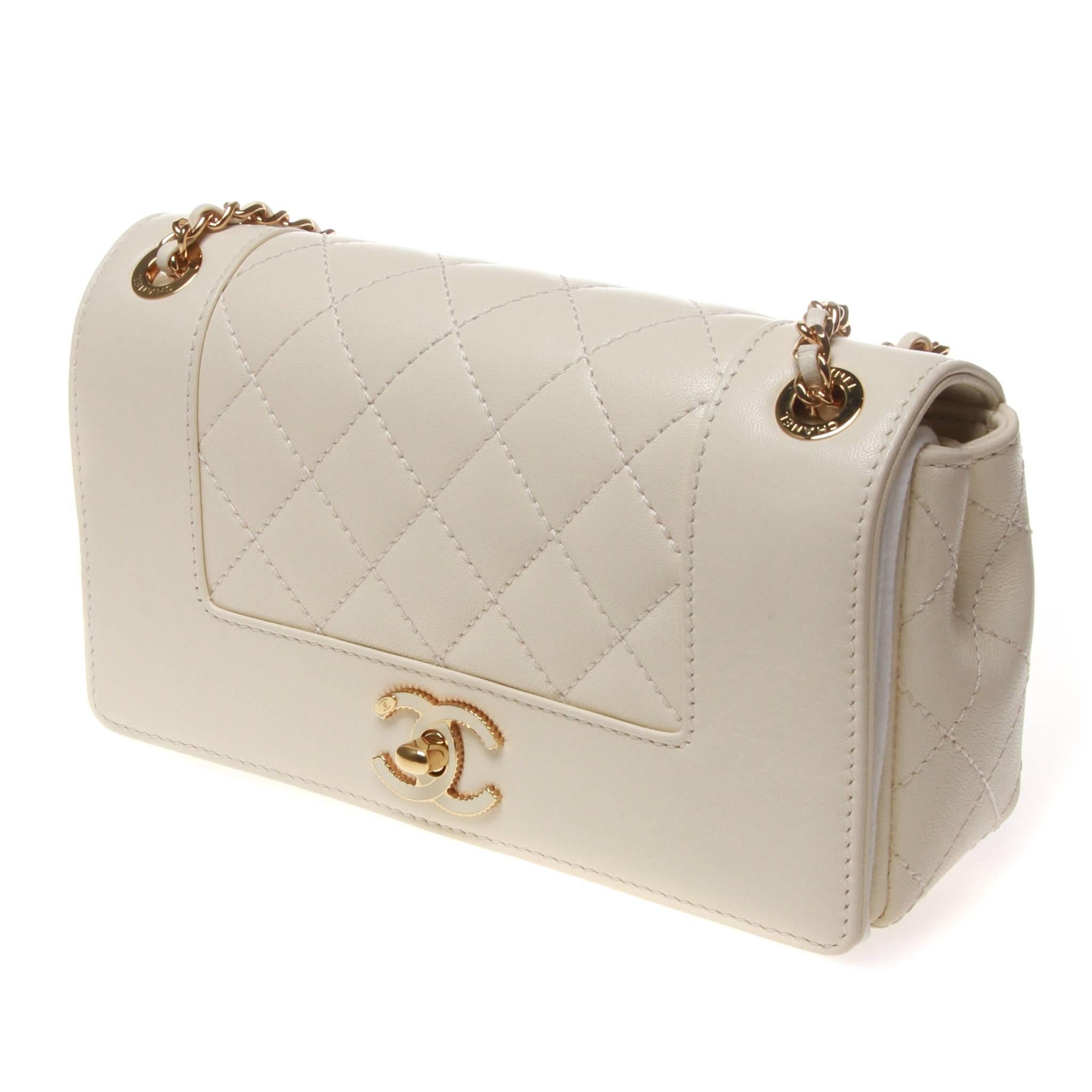  Beautiful Chanel Mademoiselle Vintage Flap Bag in ivory quilted  lambskin leather. 
Classic Chanel gold chain straps, and tone-on-tone Enamel CC Clasp.
Stitched Chanel logo on the interior of the flap. Shoulder strap can be worn short, long or as a