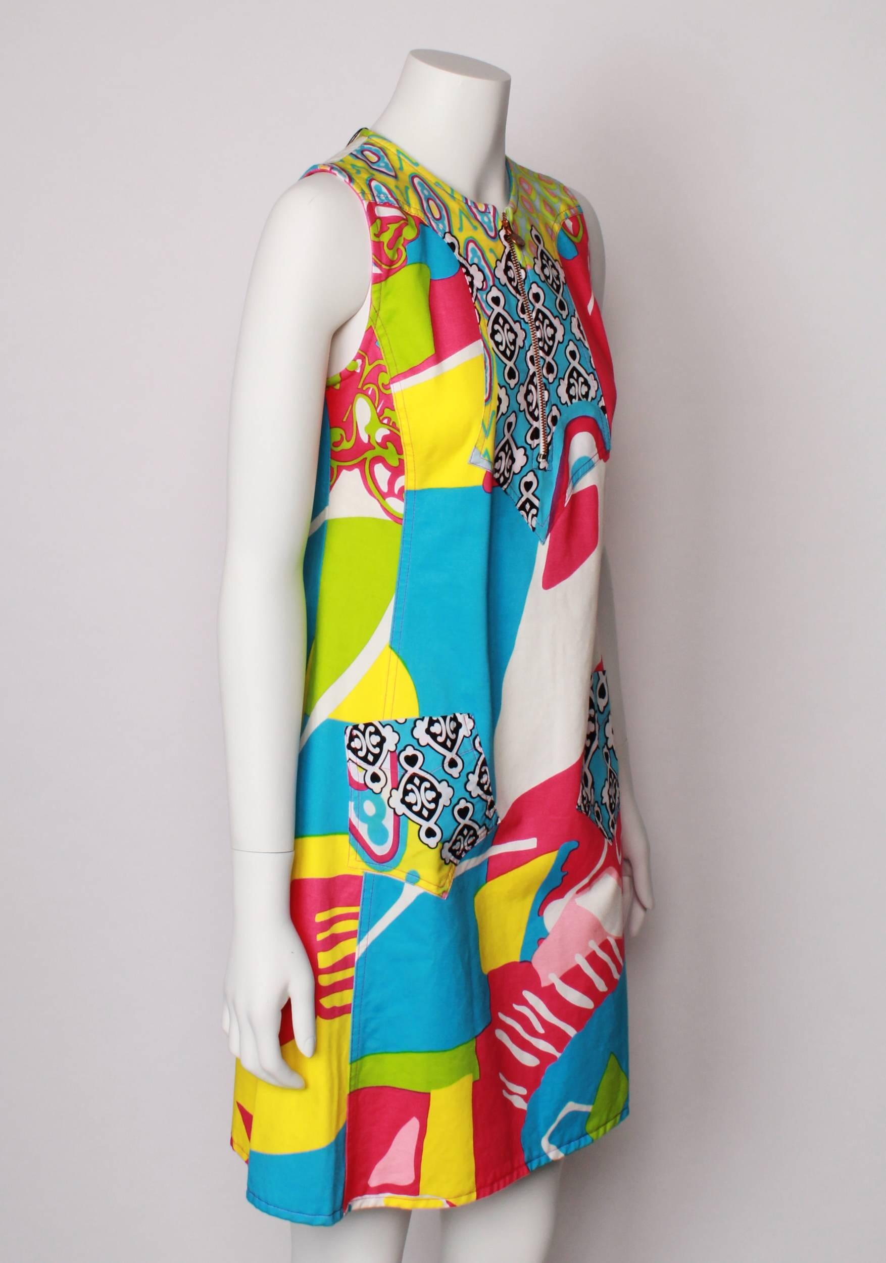 Jeans by Cristian Lacroix 100% cotton canvas Multi -coloured A-line shift sun dress. 
All over abstract print in bright hues of hot pink, turquoise, lime. yellow and white.
 Features  topstitched panels,  patch pockets, and copper feature front
