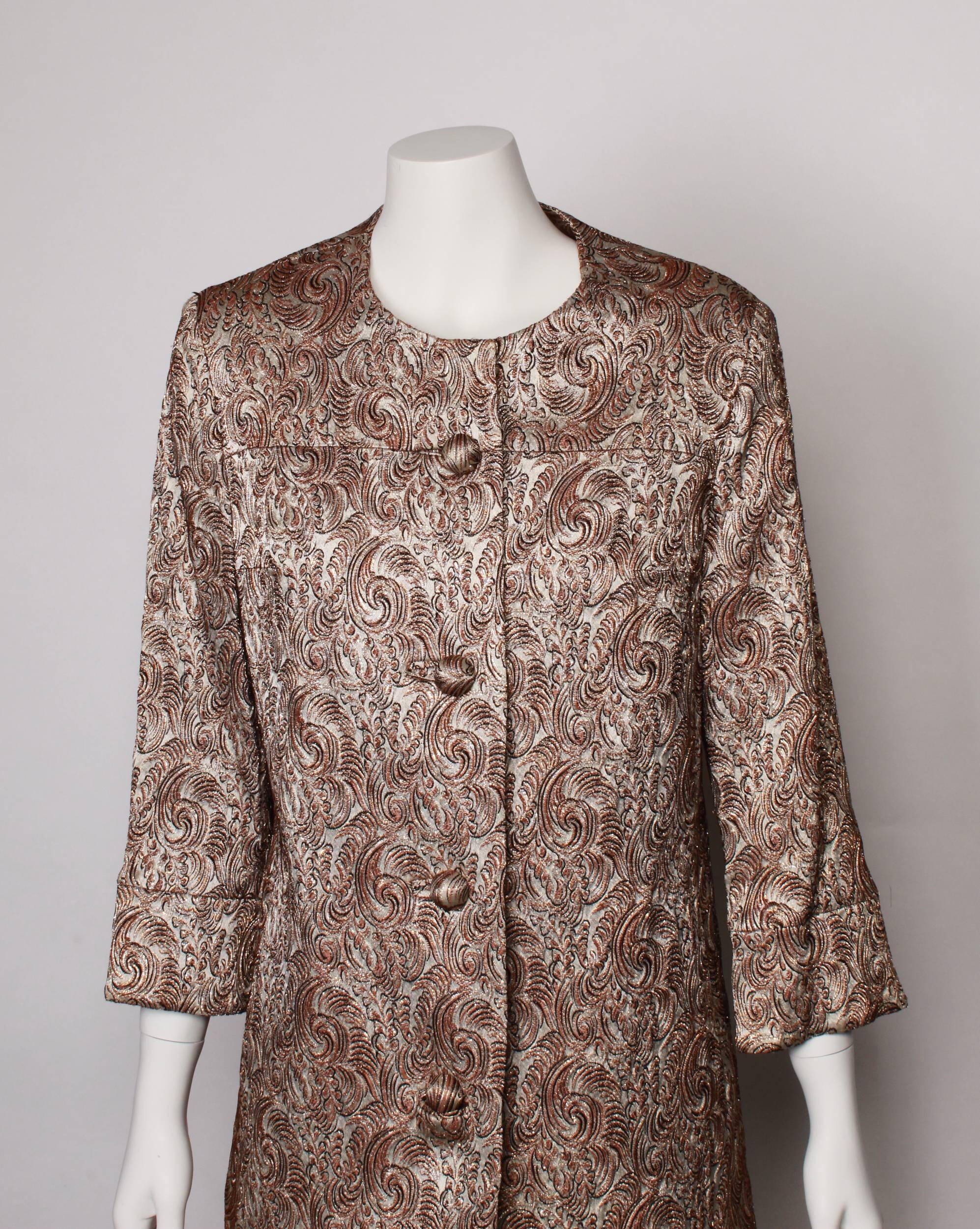 Stunning red and gold Lame` tailored Jacket from the 1960s. 
Taupe base with beautiful golden lurex, brown and black leaf textural pattern. 
Single breasted with self cover dome button closure and in seam pockets. 
3/4  sleeve with slit and button