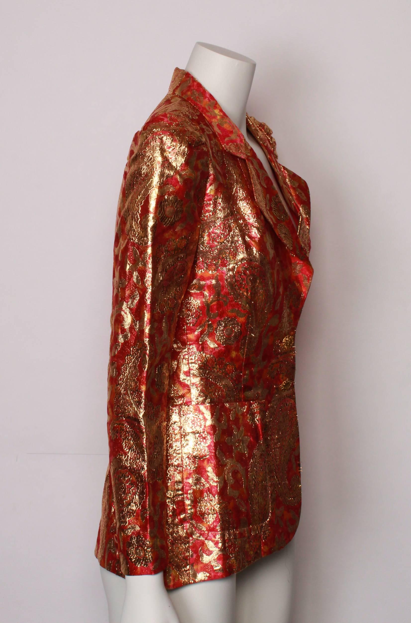 Stunning red and gold Lame` tailored Jacket from the 1970s. 
Red base with beautiful golden floral and paisley textural pattern. 
Single breasted with ornate golden button closure and patch pockets. 
Sleeve is slightly gathered at the sleeve head