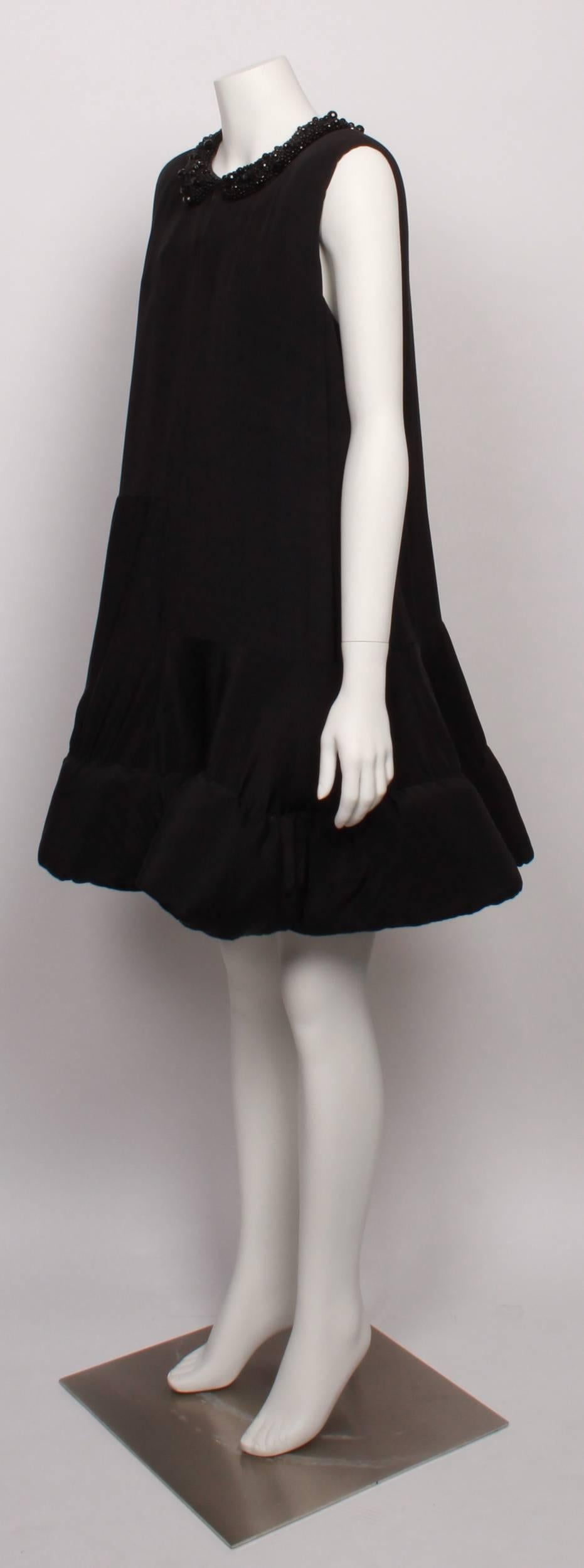JOHN ROCHA A Frame black silk party dress with jett beaded peter pan collar and padded hemline to create a stand-alone floating affect. 
Dress features contemporary abstract square and rectangular silk panels, back keyhole opening with button