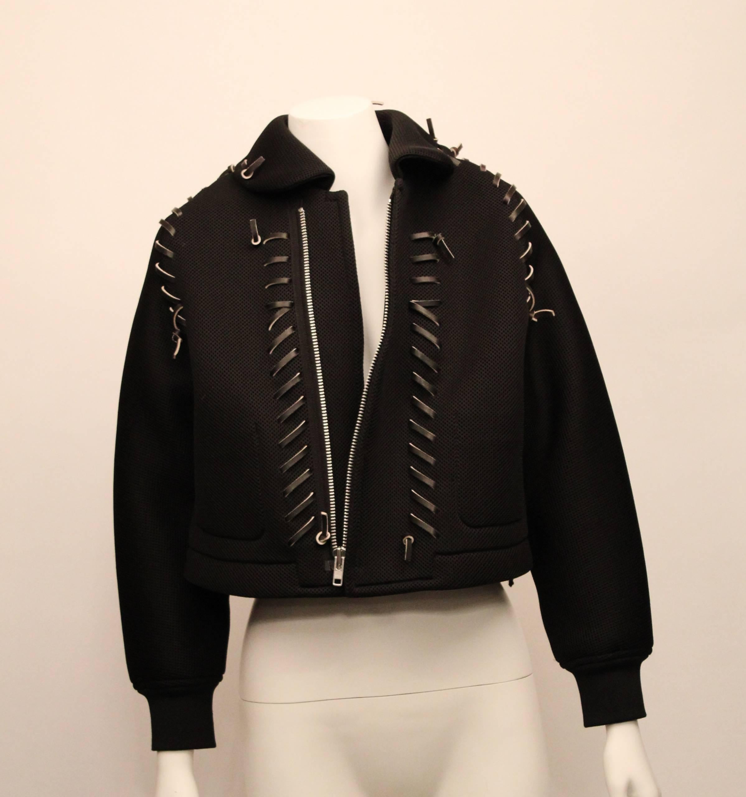 COMME DES GARCONS mesh cropped jacket from the 2004 runway collection. 
A true collectors item, this jacket was recently featured at the Met Museum's CDC exhibition.
Black mesh neoprene with dark chocolate cowhide decorative trim and statement
