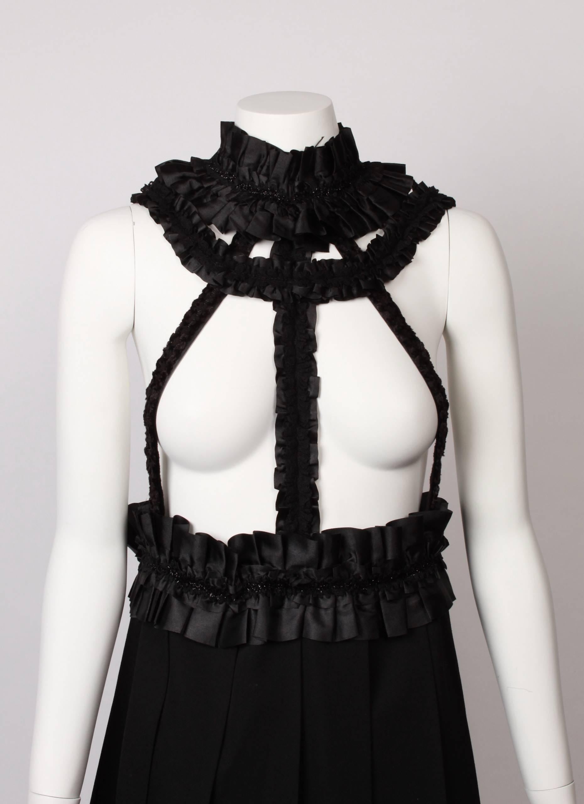 COMME DES GARCONS Evening Pinafore with satin and lace pleated and ruffled decorative straps.
Waistline and neckline feature black lurex strips.
Skirt has wide knife pleats in wool gaberdine. Pleats sit on a slight angle.
From the 2008 Collection.