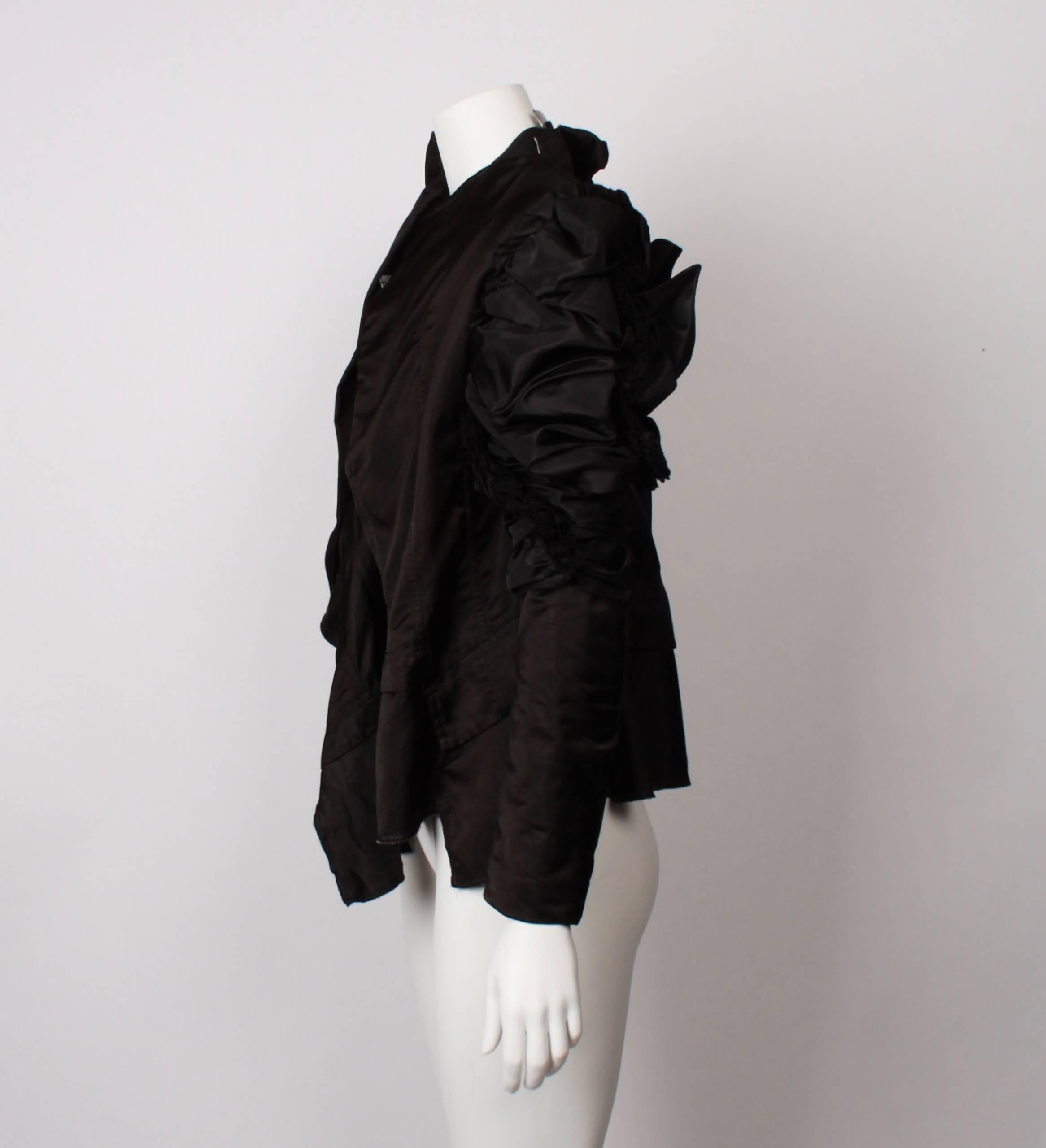 COMME DES GARCONS ruffled and gathered Asymmetric Top in black satin. 
Super gathered sleeves, with padding, asymmetric peplum and hook and eye closure. Half lined. 
From the 2004 collection.