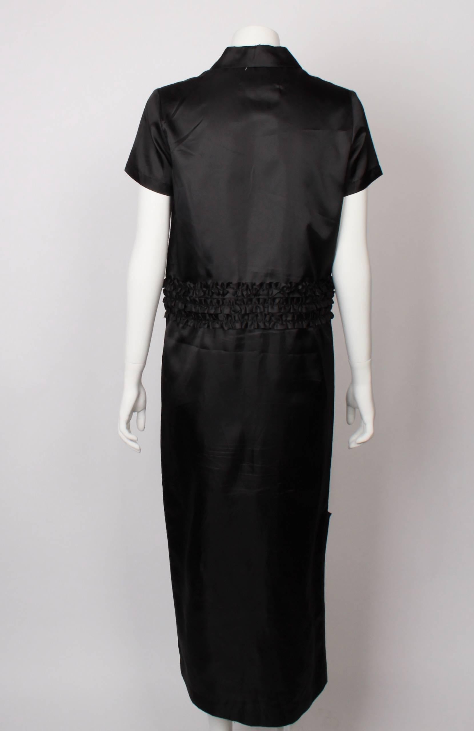 FINAL SALE
Madam Virtue & Co

COMME DES GARCONS TRICOT 2 Piece Ruffle Dress in black hi tech polyester. 
Dress cleverly converts and unzips into 2 pieces - a shirt and a skirt. Three garments in one.....
Features nickel zipper at waistline with