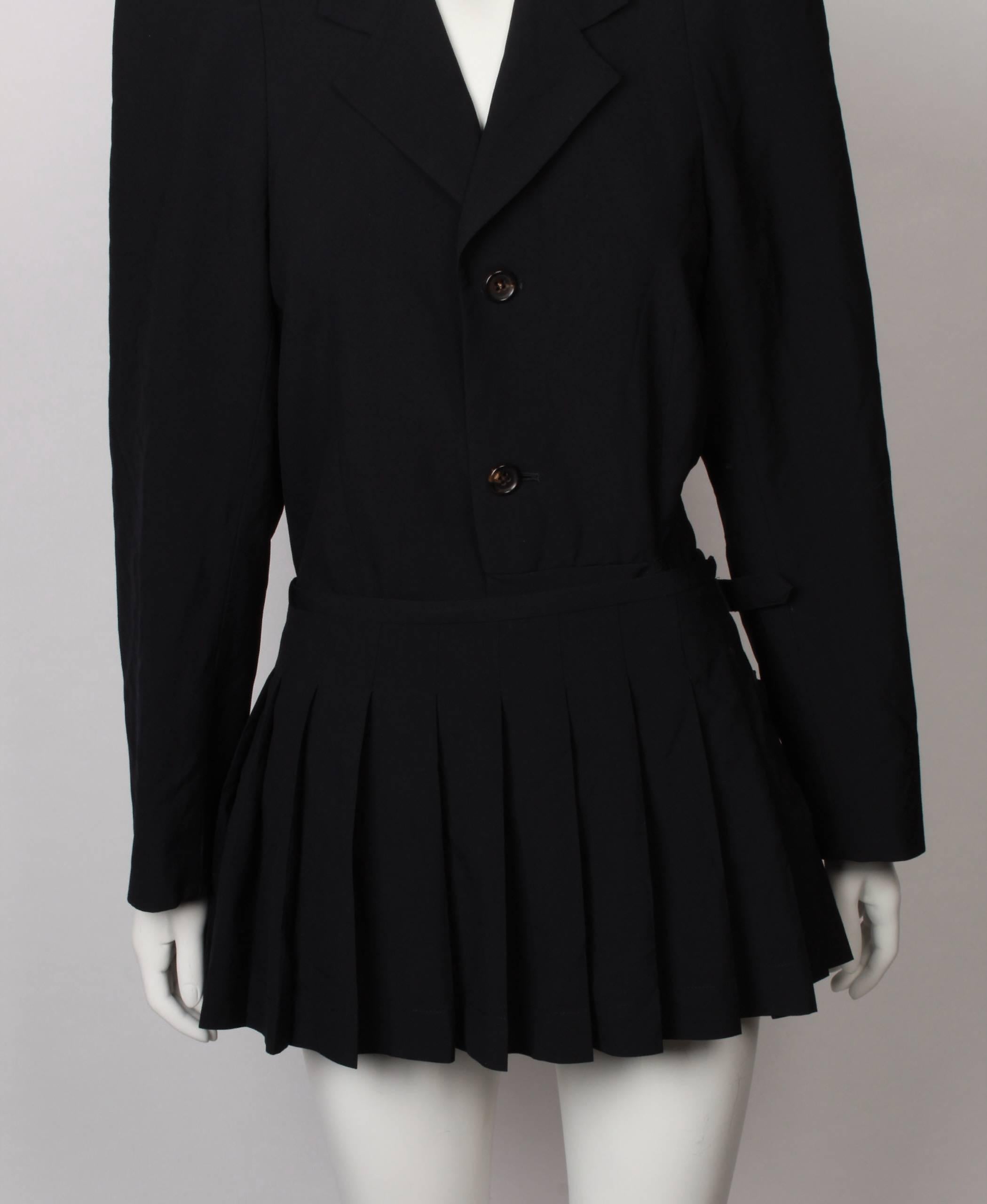 Comme des Garcons 1989 collection jacket with pointed shoulders and attached pleated kilt/skirt in black wool gaberdine. Dart in sleeve head creates peaked shape.
Can be worn many different ways. Iconic CDC.
Half lined with welt pockets with flap.
