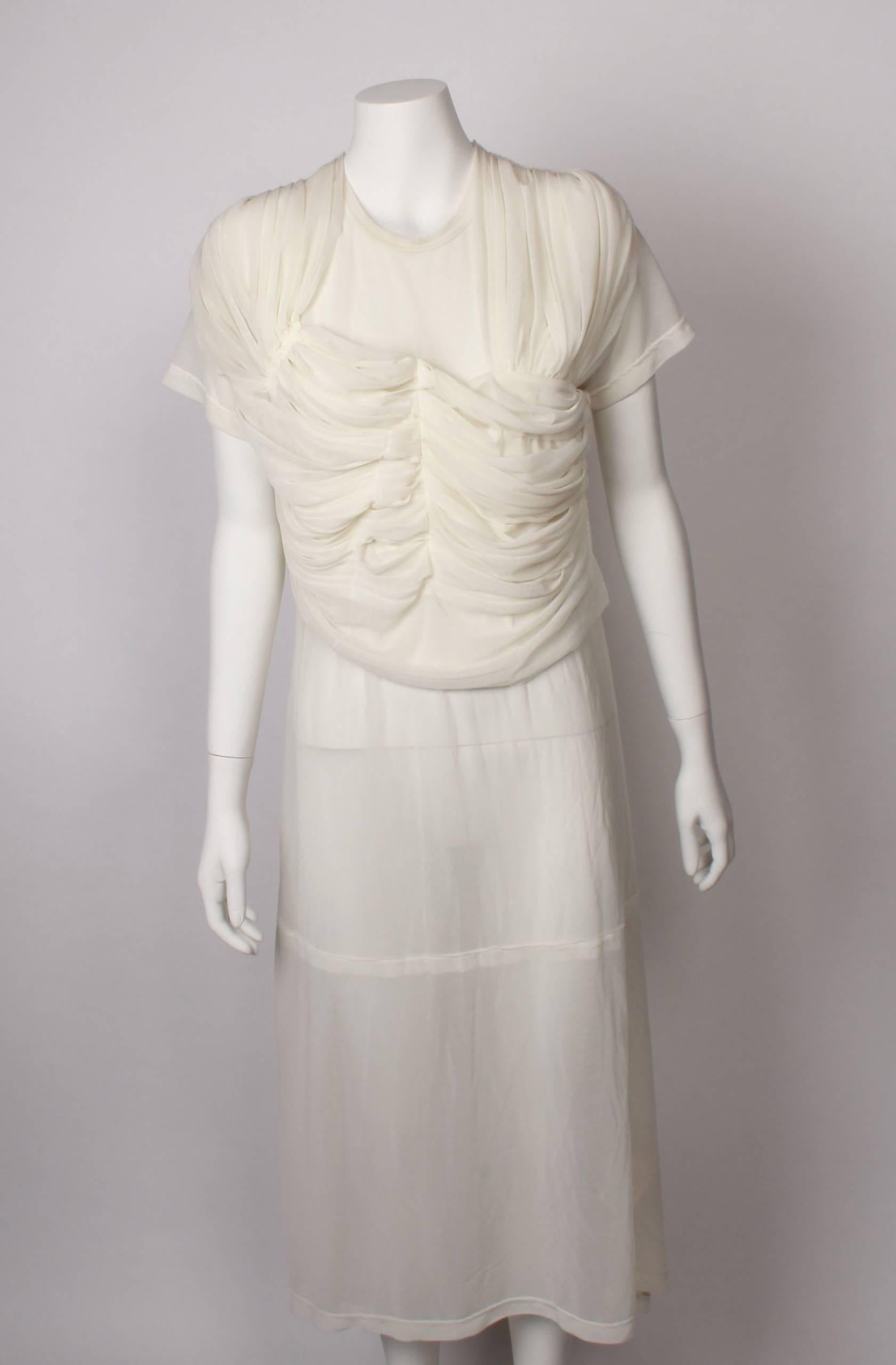 Comme Des Garcons sheer silk jersey draped dress. Stunning and elegant, featuring short sleeve and draped bodice to hip.
Hemline is curved and slightly longer at the back. 
Beautiful and timeless. A classic for the CDG enthusiast!