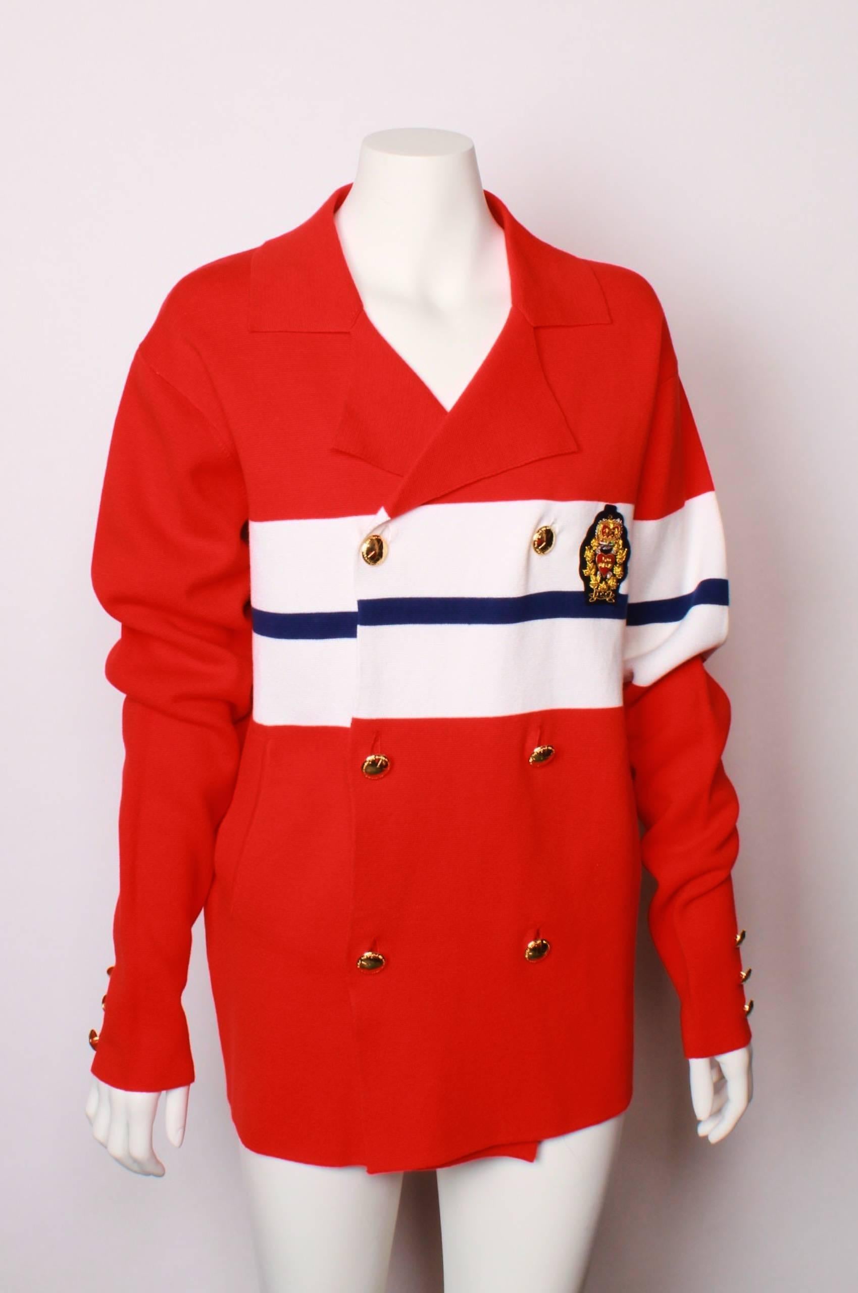 Nautical theme-Heavy cotton knit double breasted jacket.
Features gold embroidered crown & 'Love Pirates' heart  applique motif on left hand side.
There are 3 double rows of gold plated buttons on the front and three smaller buttons on each